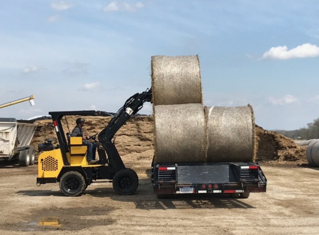 Compact Loader stacking hay bales